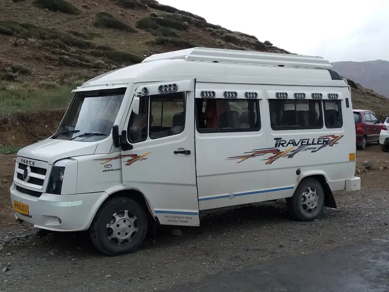 Force Tempo Traveller minibus on a Himalayan mountain highway